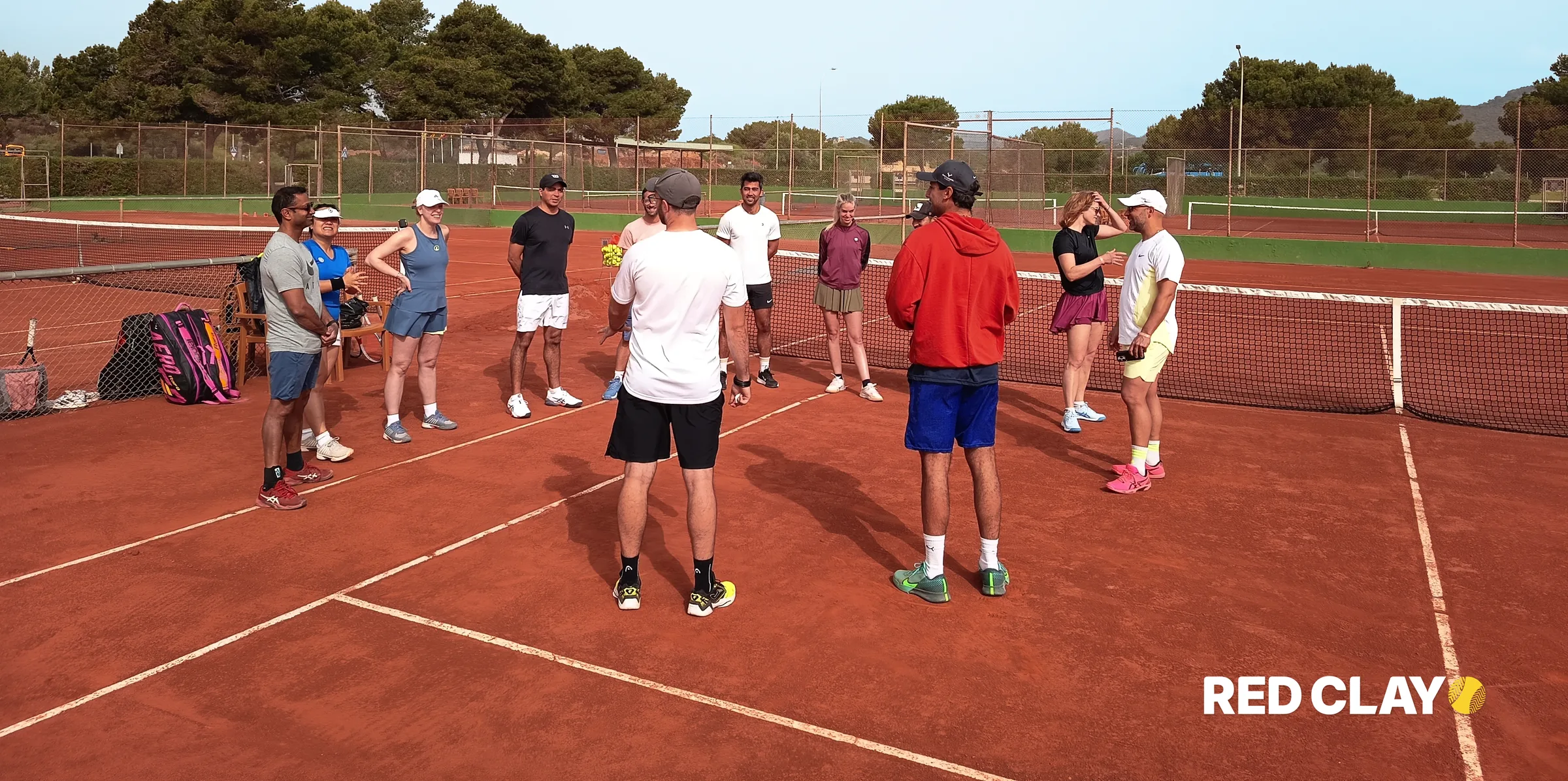 Group coaching on a red clay court in Mallorca